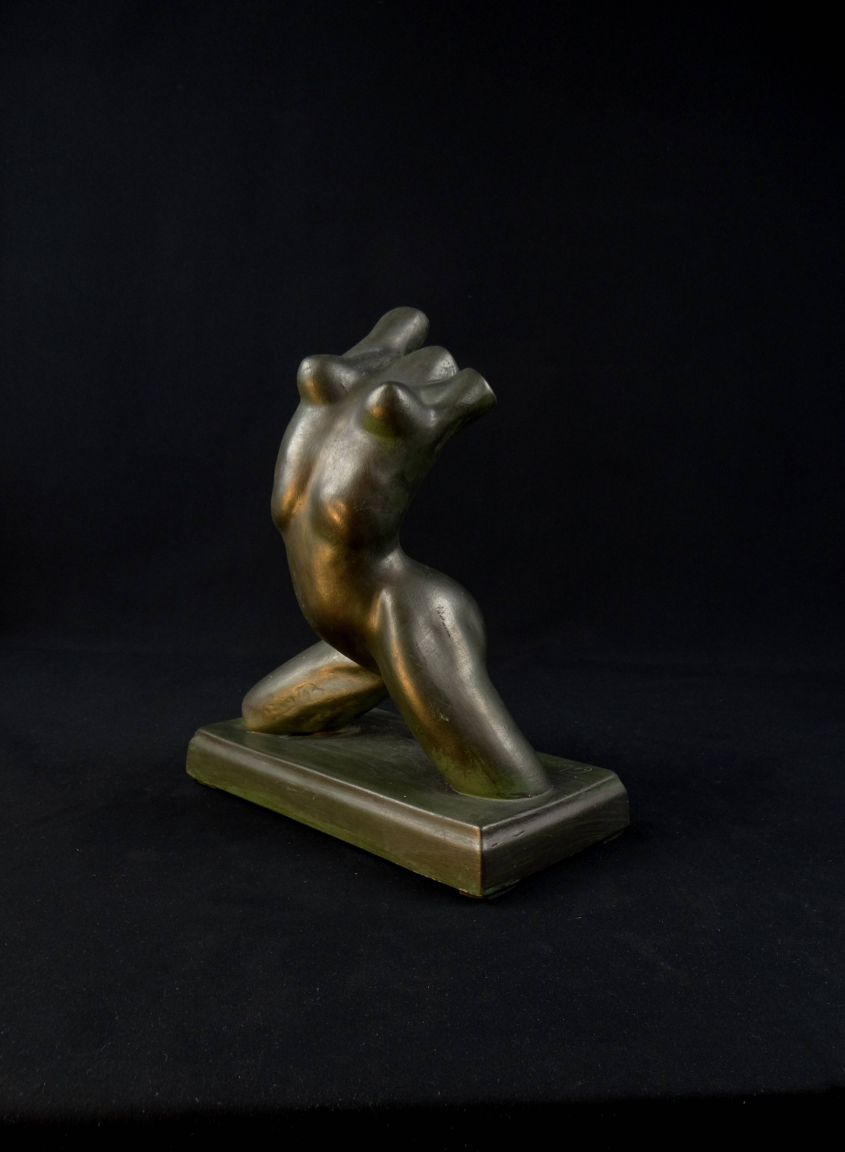 Modern sculpture of a nude woman in green ceramic, signed Carlos Nazareth