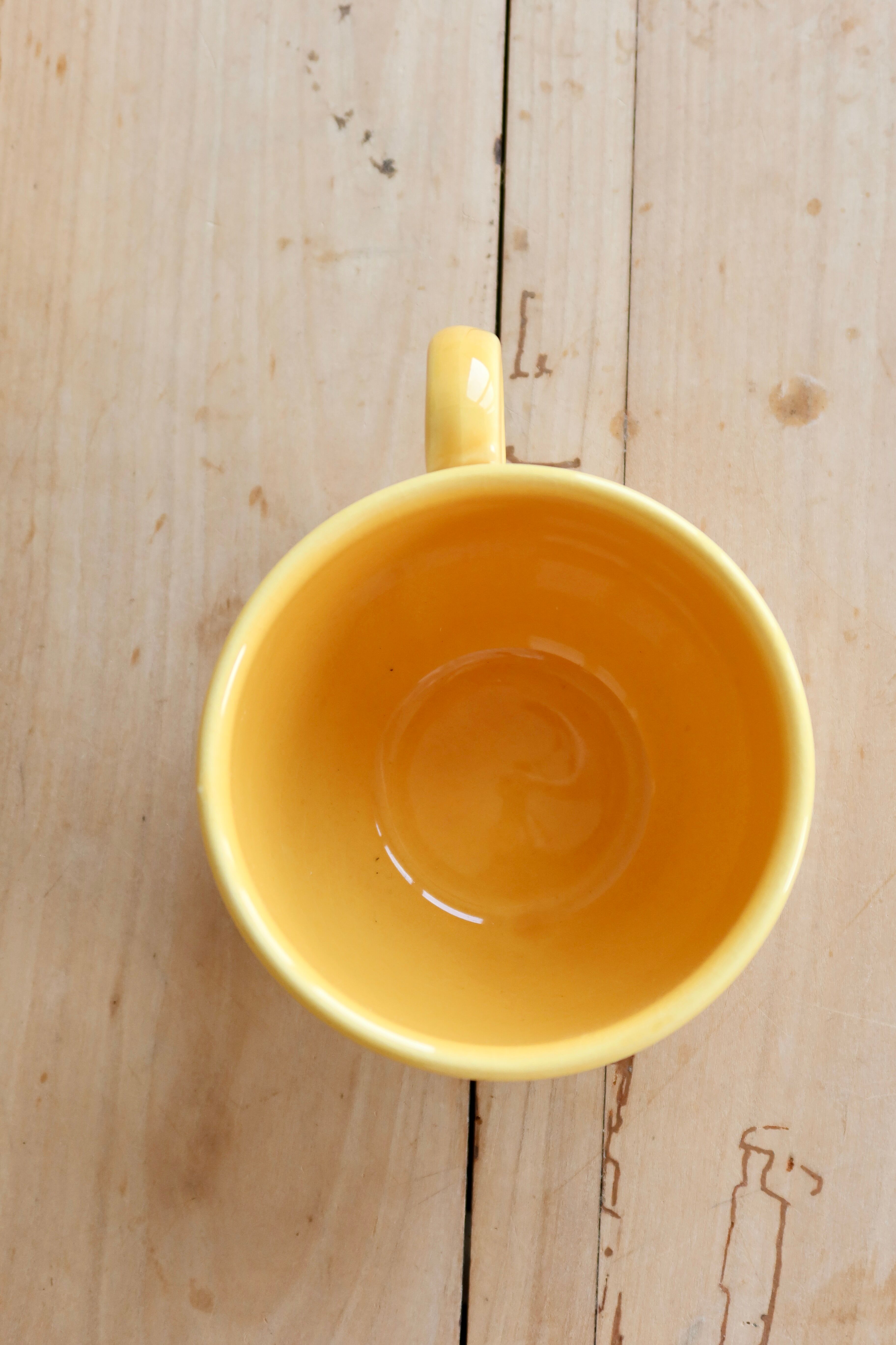 Large vintage ceramic mug in yellow with hand-painted flowers.