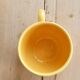 Large vintage ceramic mug in yellow with hand-painted flowers.