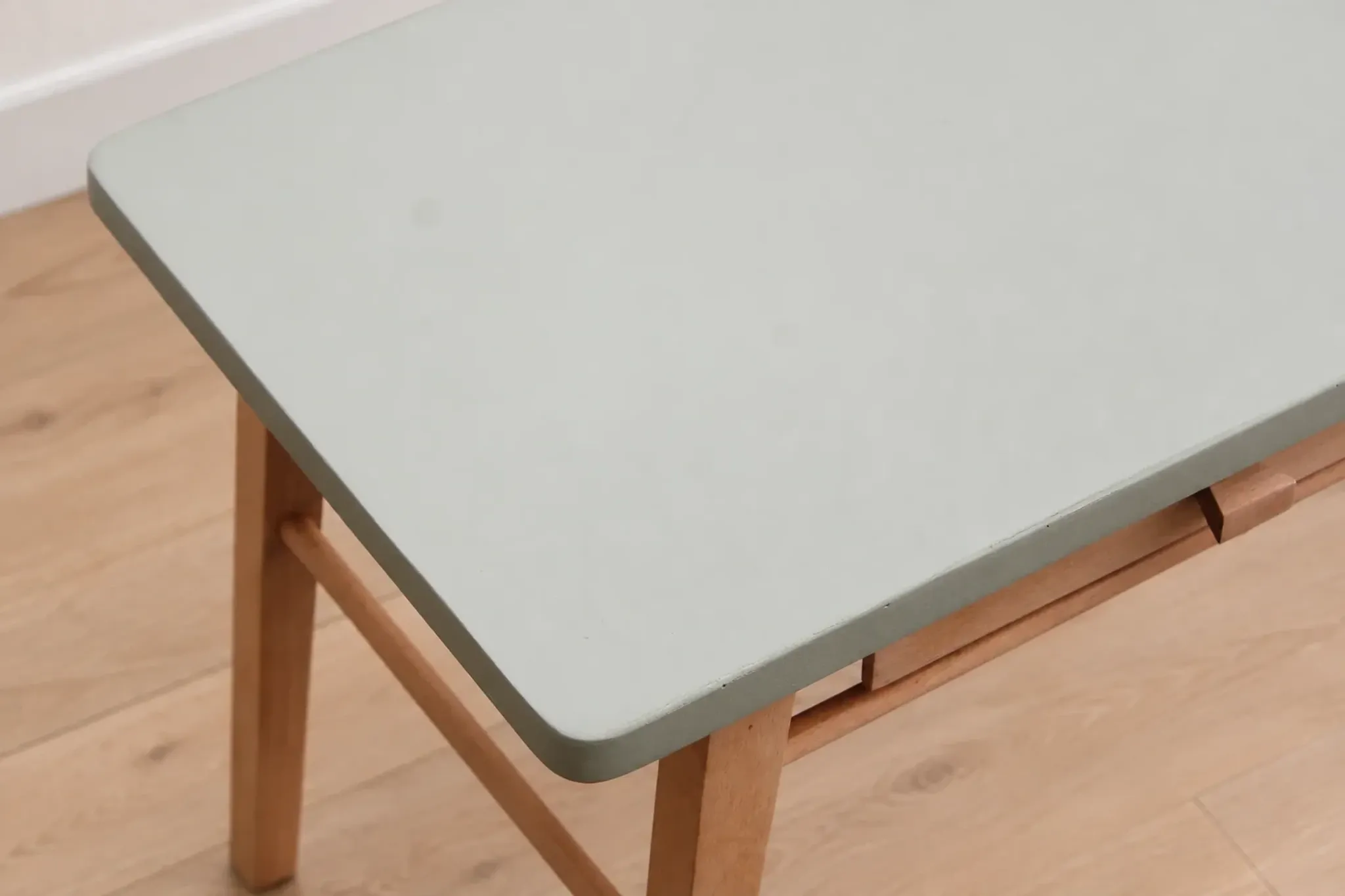 Small vintage children's desk attributed to Baumann – natural wood and lizard green top.