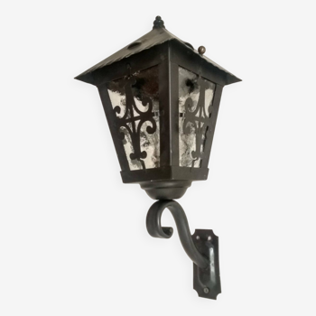 Old wall light - wrought iron lantern and opaque windows