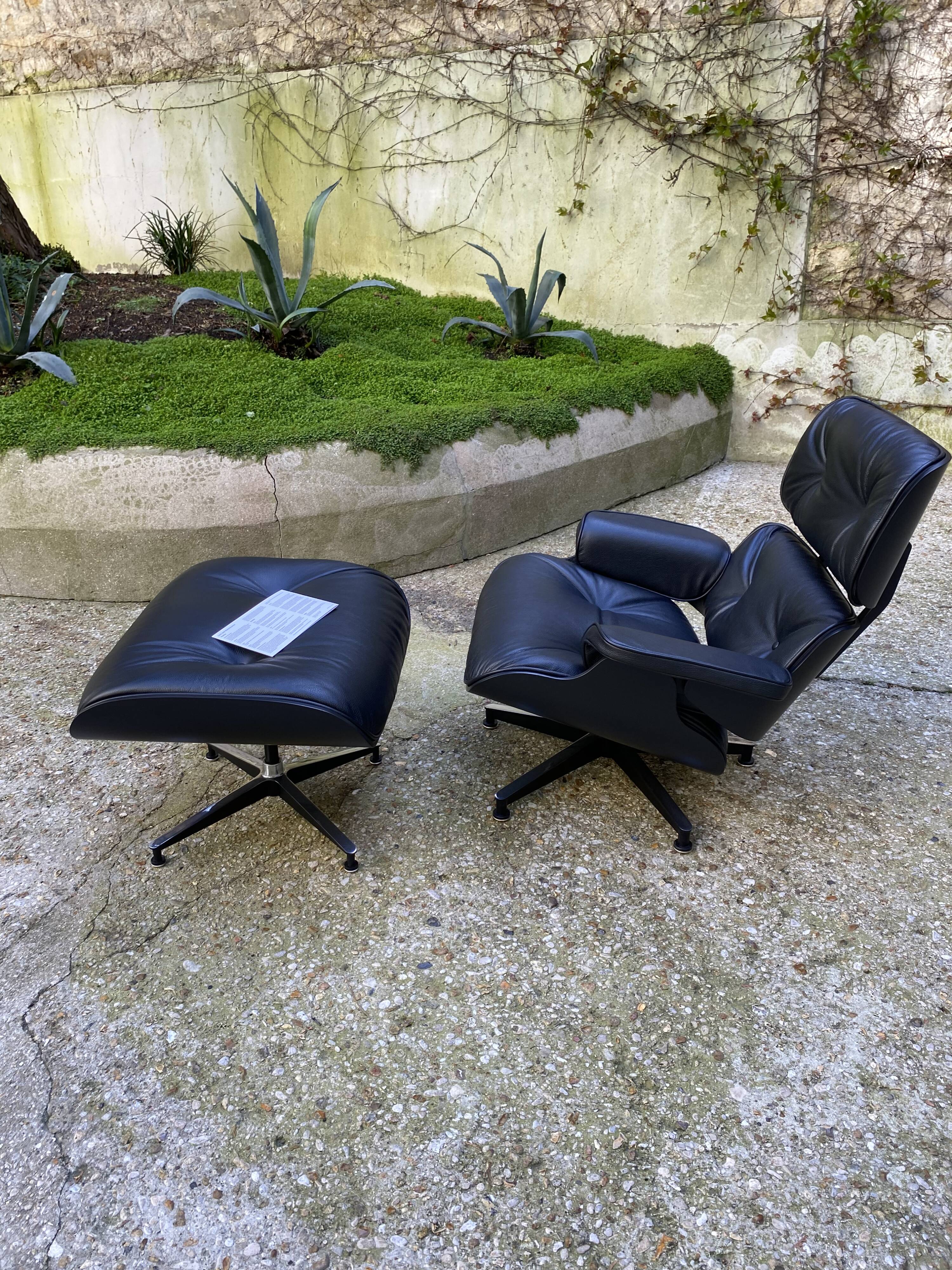 Charles Eames all-black lounge chair and ottoman, Herman Miller edition