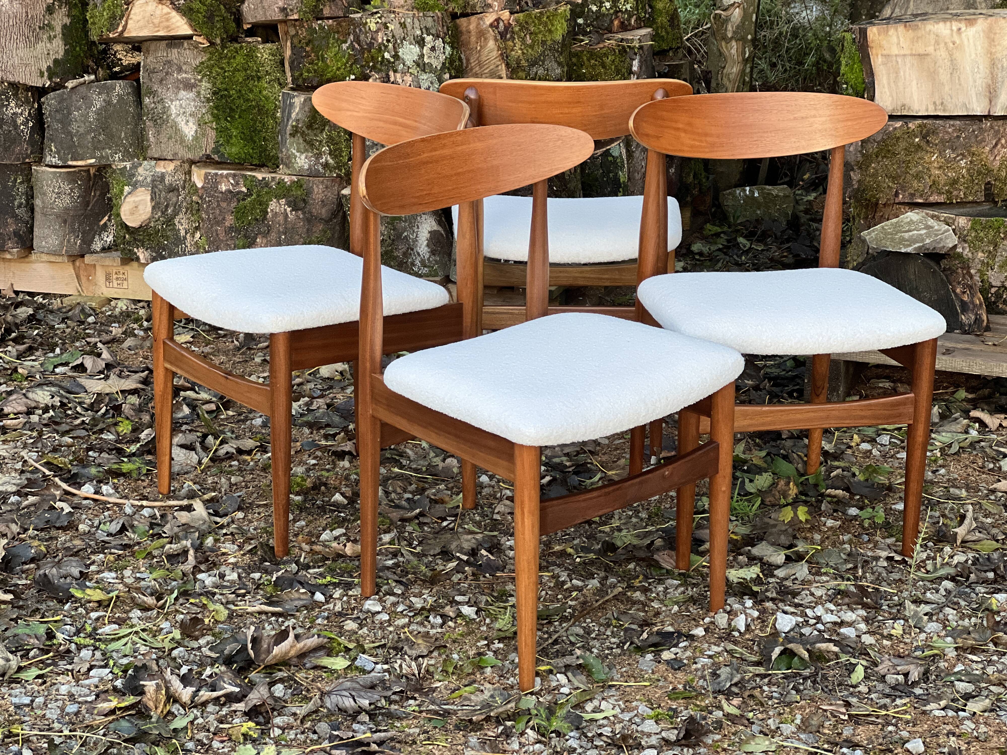 A set of GPlan chairs in teak with a white woolly fabric