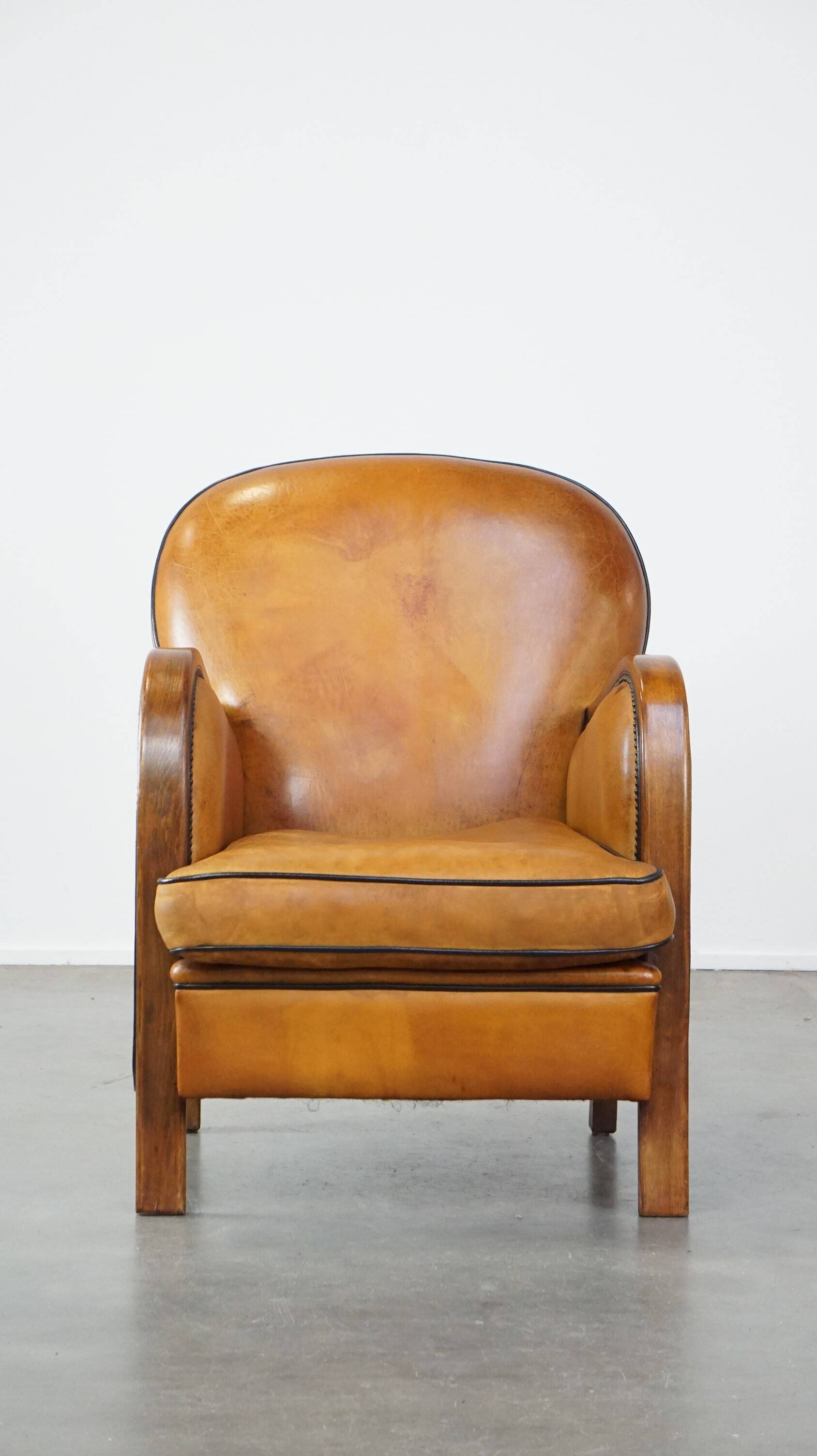 Unique, luxurious sheepskin armchair combined with wood and finished with decorative nails