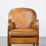 Unique, luxurious sheepskin armchair combined with wood and finished with decorative nails