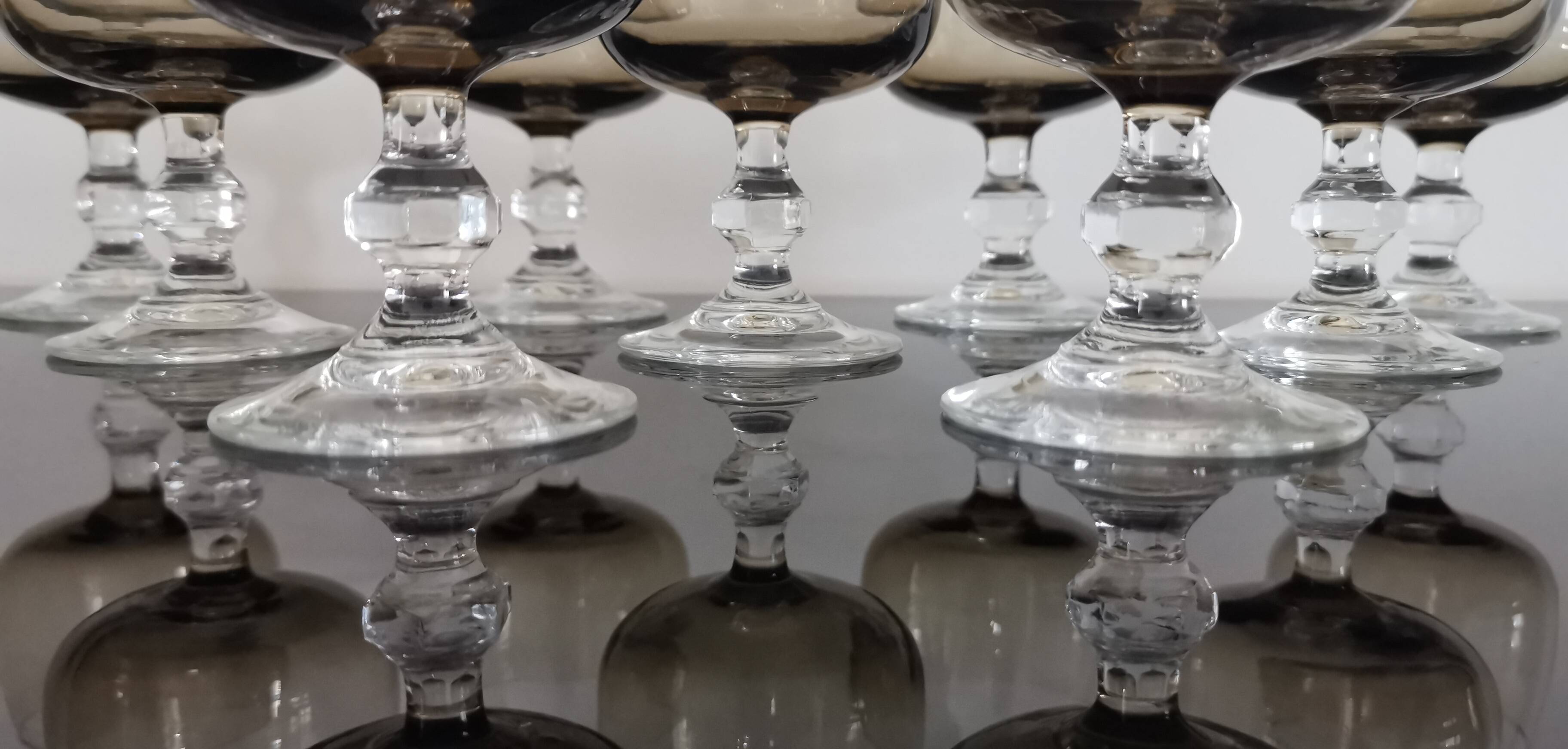 9 white wine glasses on vintage Luminarc smoked black stem