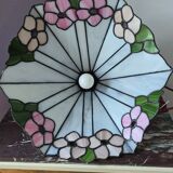 Tiffany-style stained glass lampshade with floral motifs.