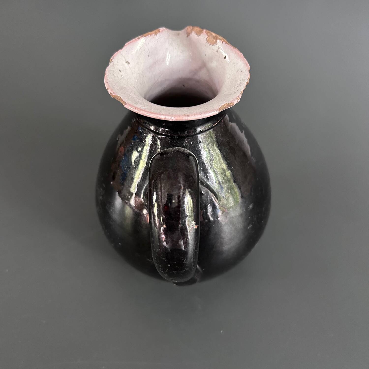 Antique black pitcher with white collar