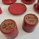 Red enamelled terracotta: cups, saucers, glasses