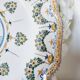 Antique plate in Moustiers faience, hand-painted, decorated with an s