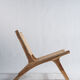 Reclining armchair in natural wood and woven rattan