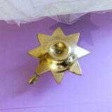 Golden brass hand candle holder decorated with leaves