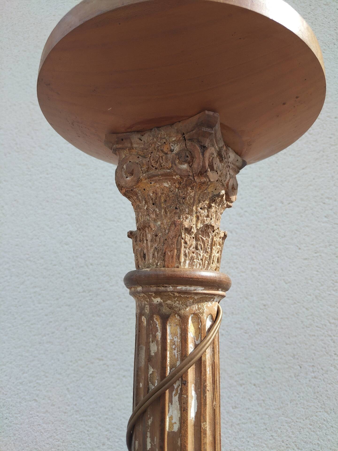 Large antique church candlestick in carved wood transformed into a lamp.