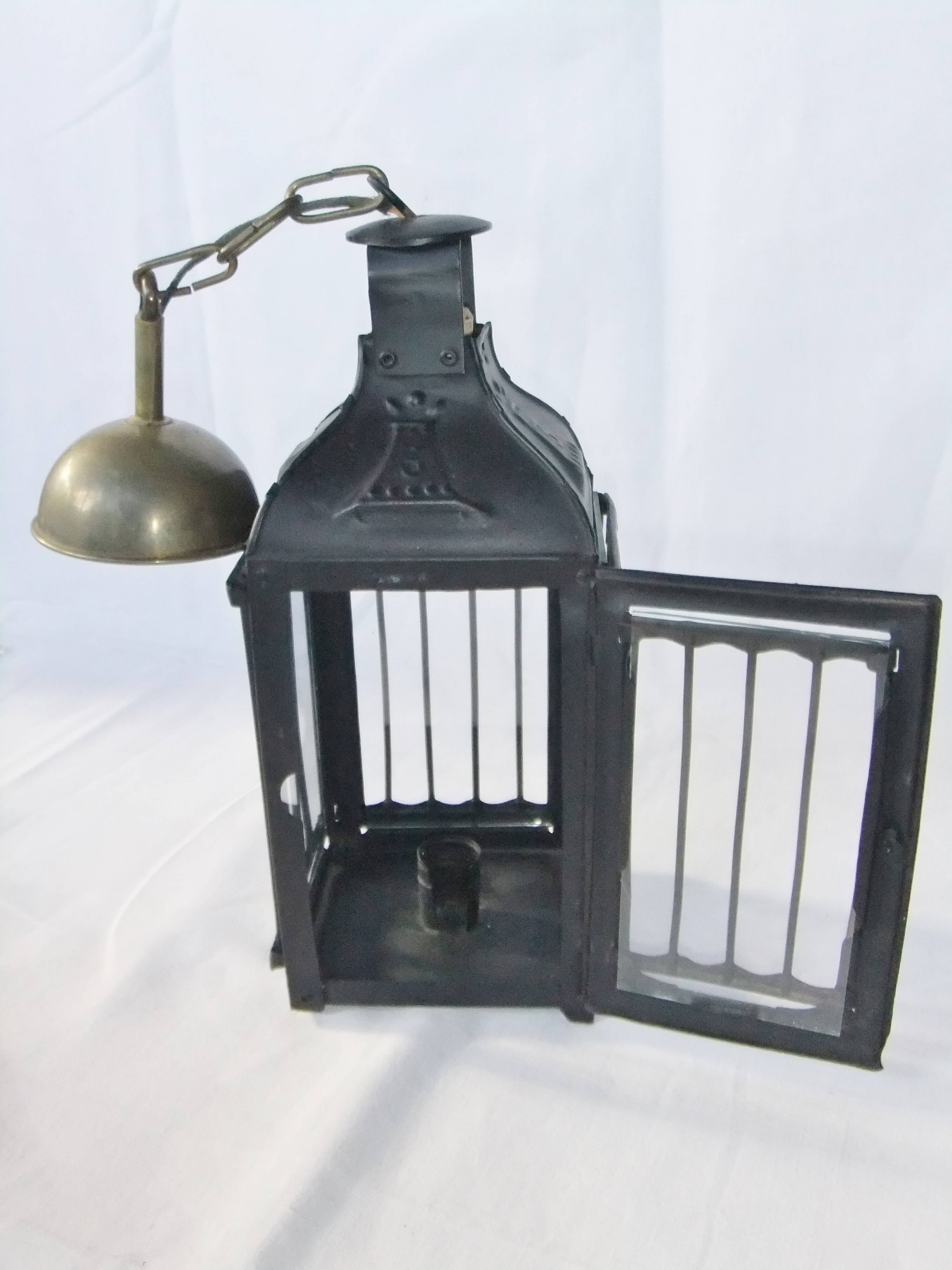 Old chandelier hanging lantern with candle in sheet metal