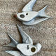 Old pair of porcelain birds for wall decoration.