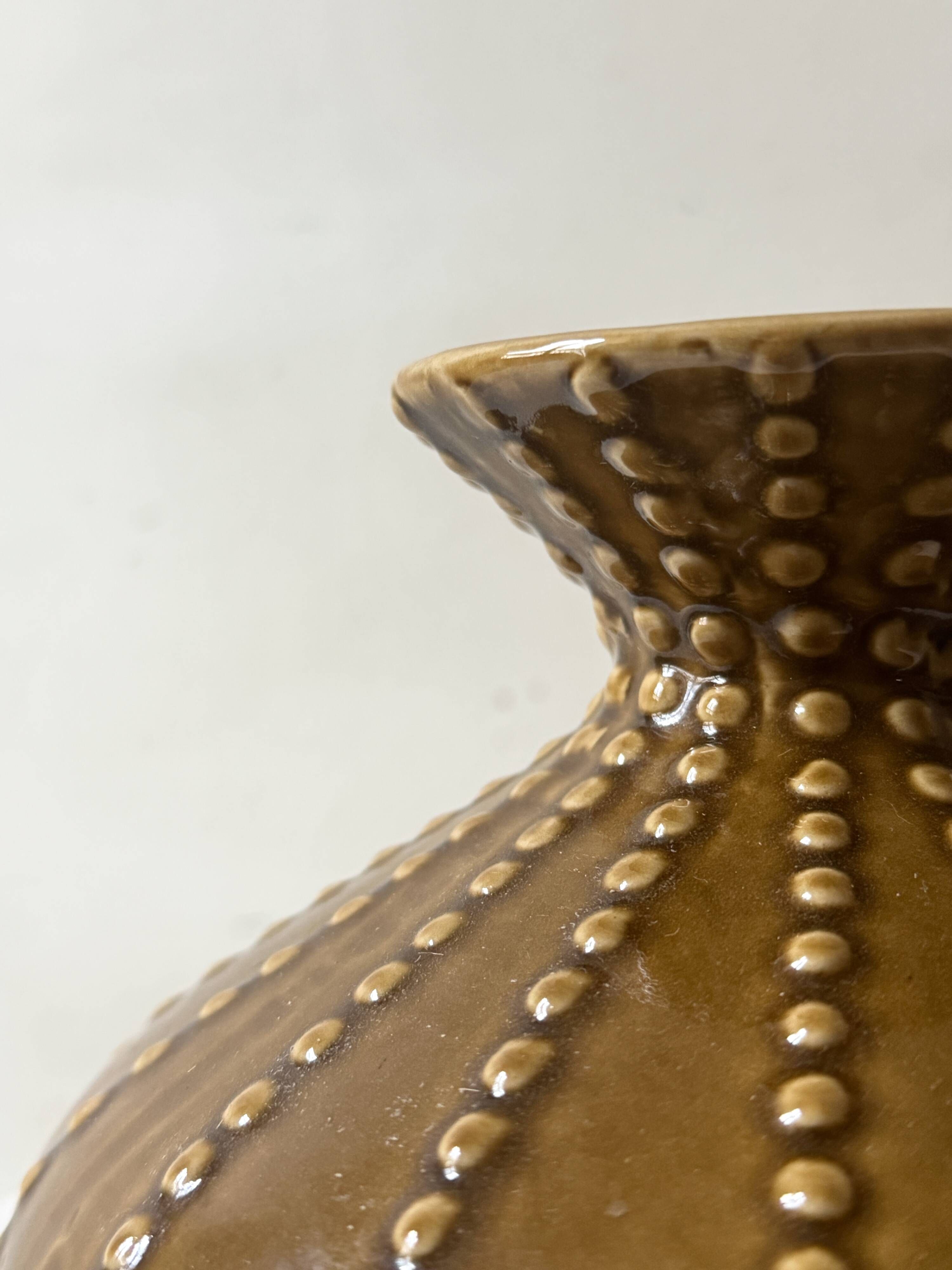 Pyriform vase in glazed ochre ceramic and beads.