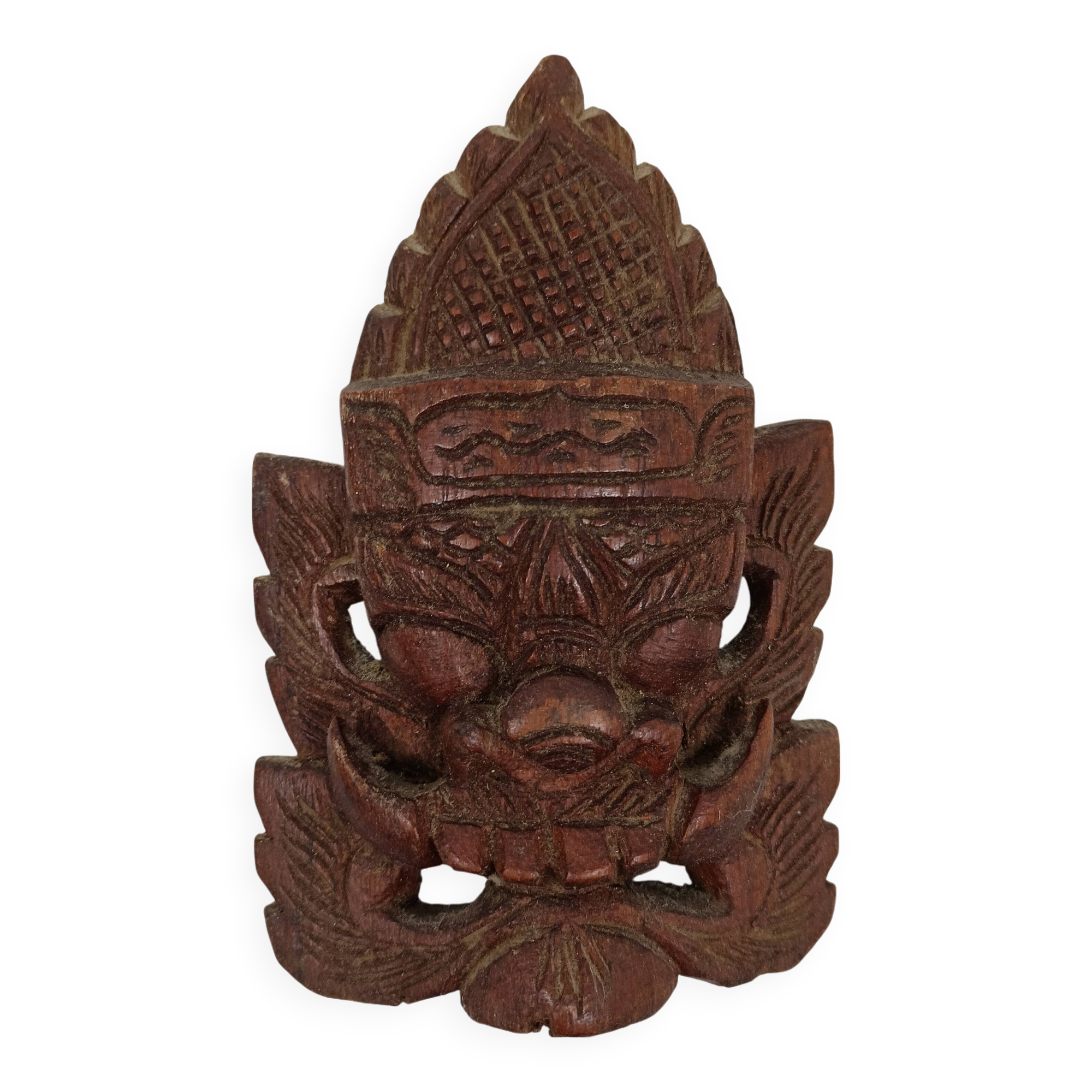 Asian decorative mask in carved wood
