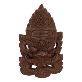 Asian decorative mask in carved wood