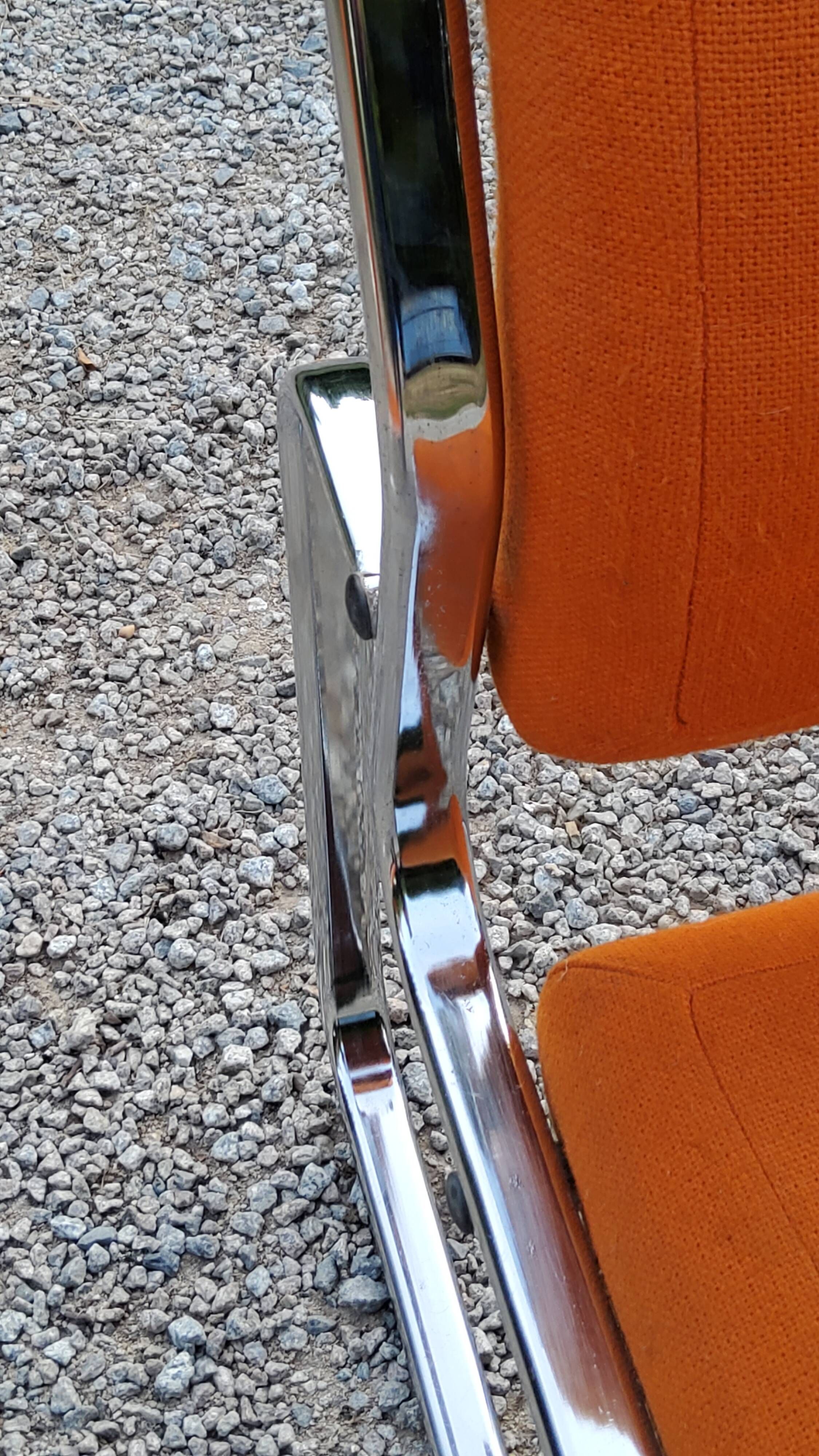 Pair of designer armchairs in orange fabrics and chrome tubes from the 70s