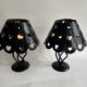 Pair of black wrought iron lanterns with heart patterns, romantic style.