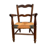 Old armchair for children in wood and straw