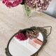 Oval mirror in gilded brass