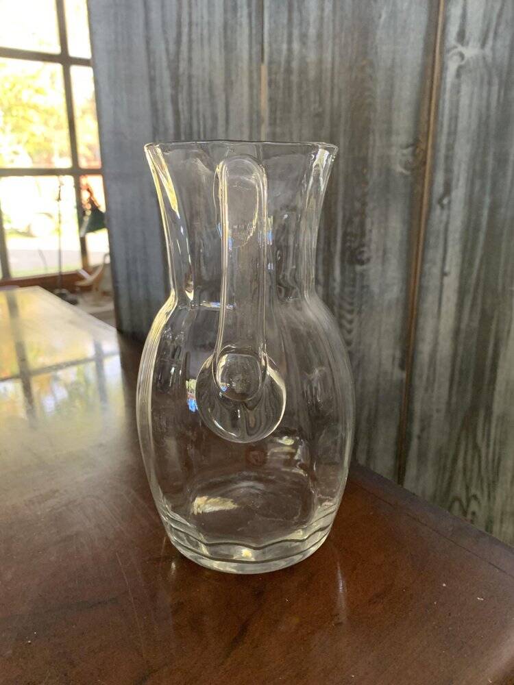 Transparent glass pitcher Mid-Century (1960s) — Czech Republic, bulbous silhouette and integrated handle.