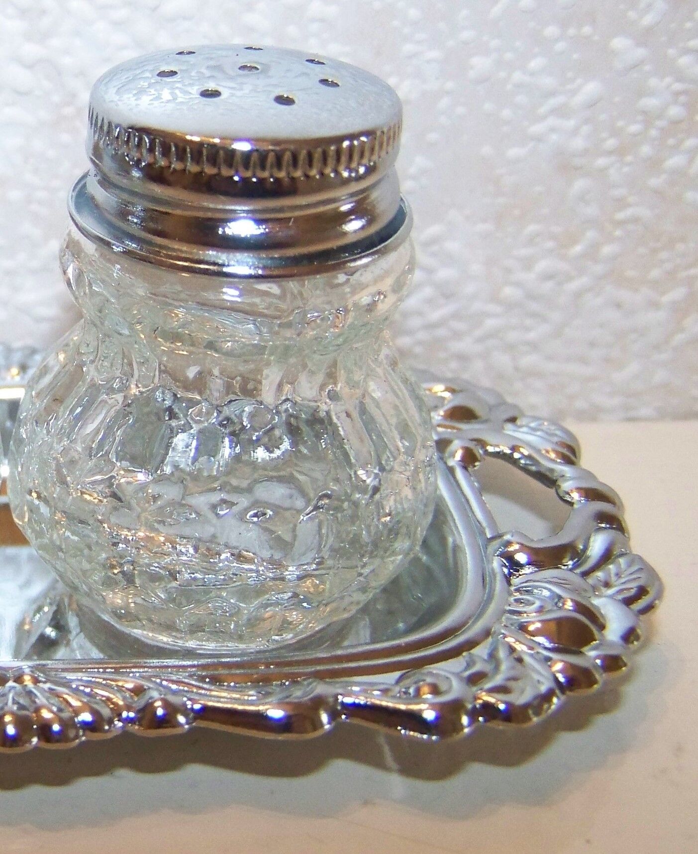 Salt shaker, pepper pot on a silver tray