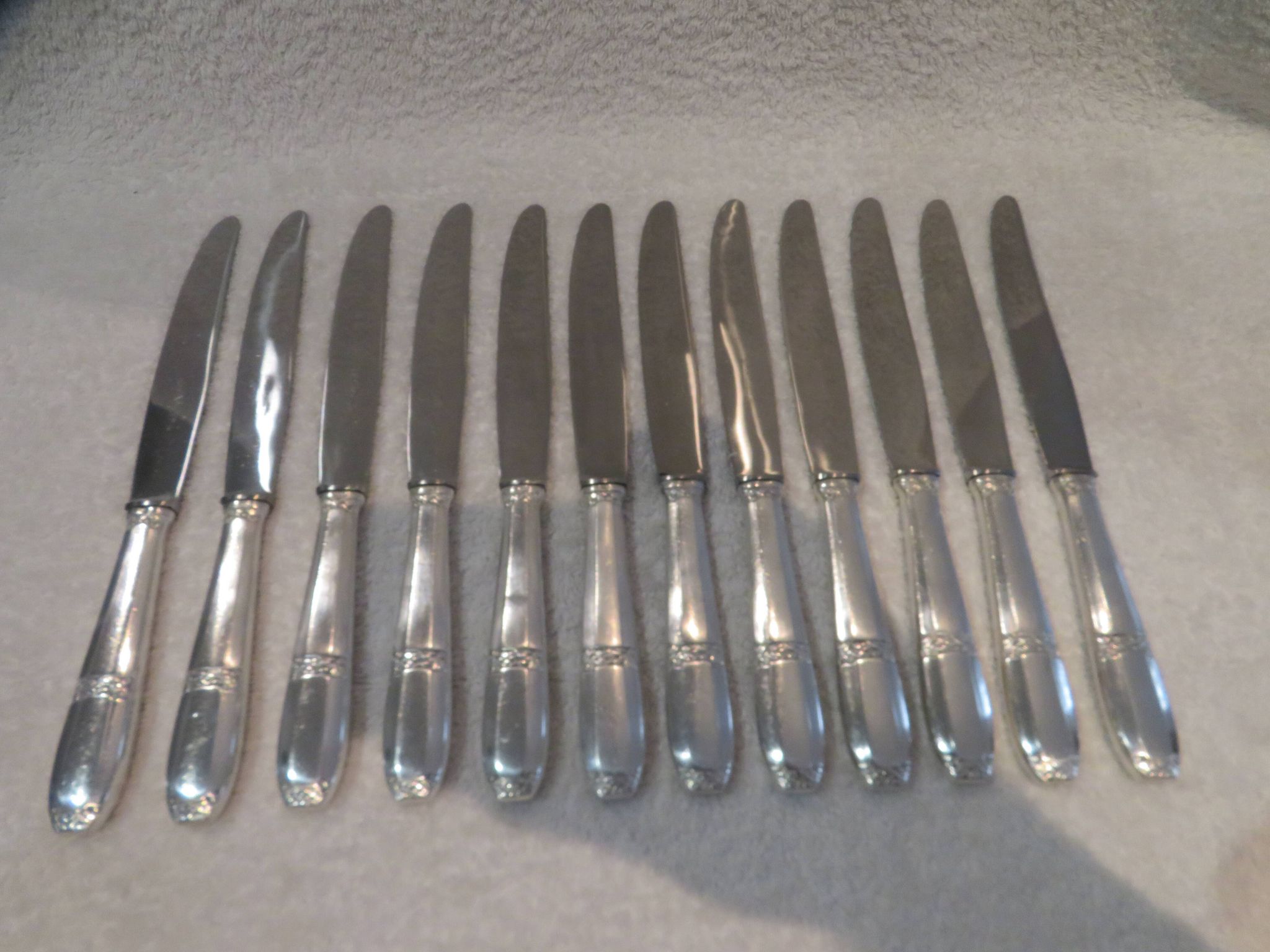 12 silver plated table knives by Argit goldsmith? Art Deco floral bands