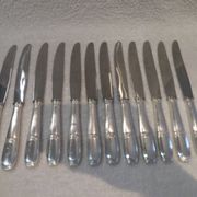 12 silver plated table knives by Argit goldsmith? Art Deco floral bands