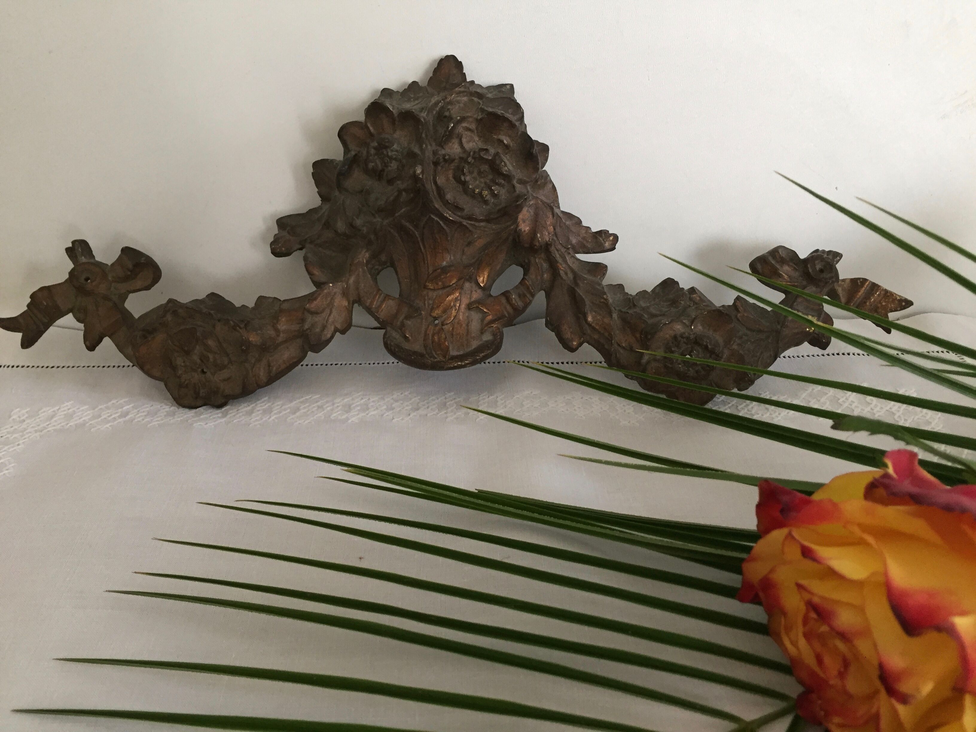 Old brass pediment, floral motifs and ribbon