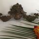 Old brass pediment, floral motifs and ribbon