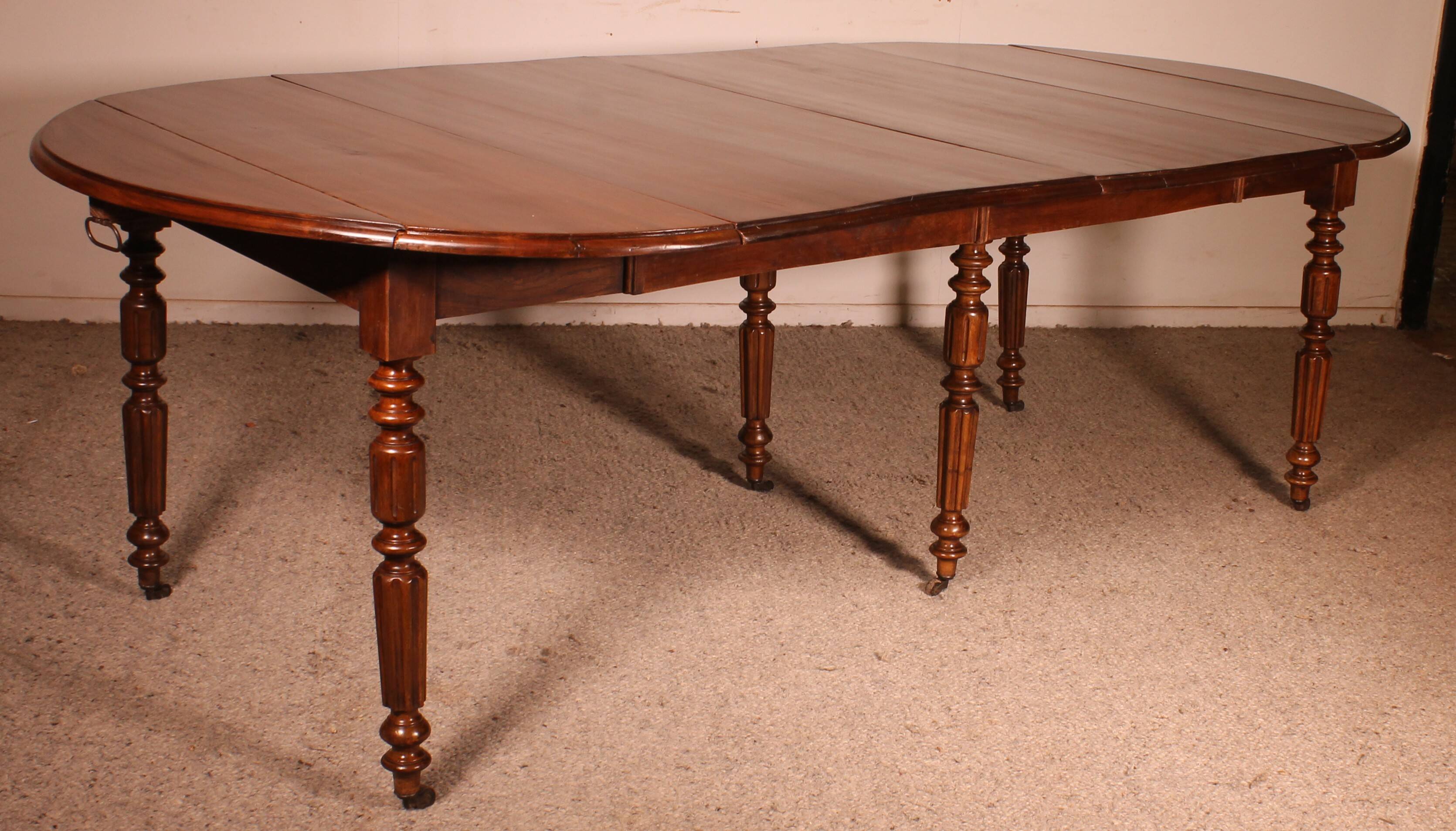 Extensible dining table from the early 19th century in walnut.