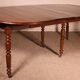 Extensible dining table from the early 19th century in walnut.