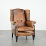 Large and comfortable sheepskin leather wingback chair with black piping