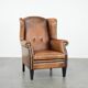 Large and comfortable sheepskin leather wingback chair with black piping