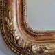 Miroir Louis-Philippe en bois et stuc doré à décor floral, XIXe, 43x38 cm