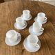 Espresso coffee cup service, Nestlé promotional items, in white glass.