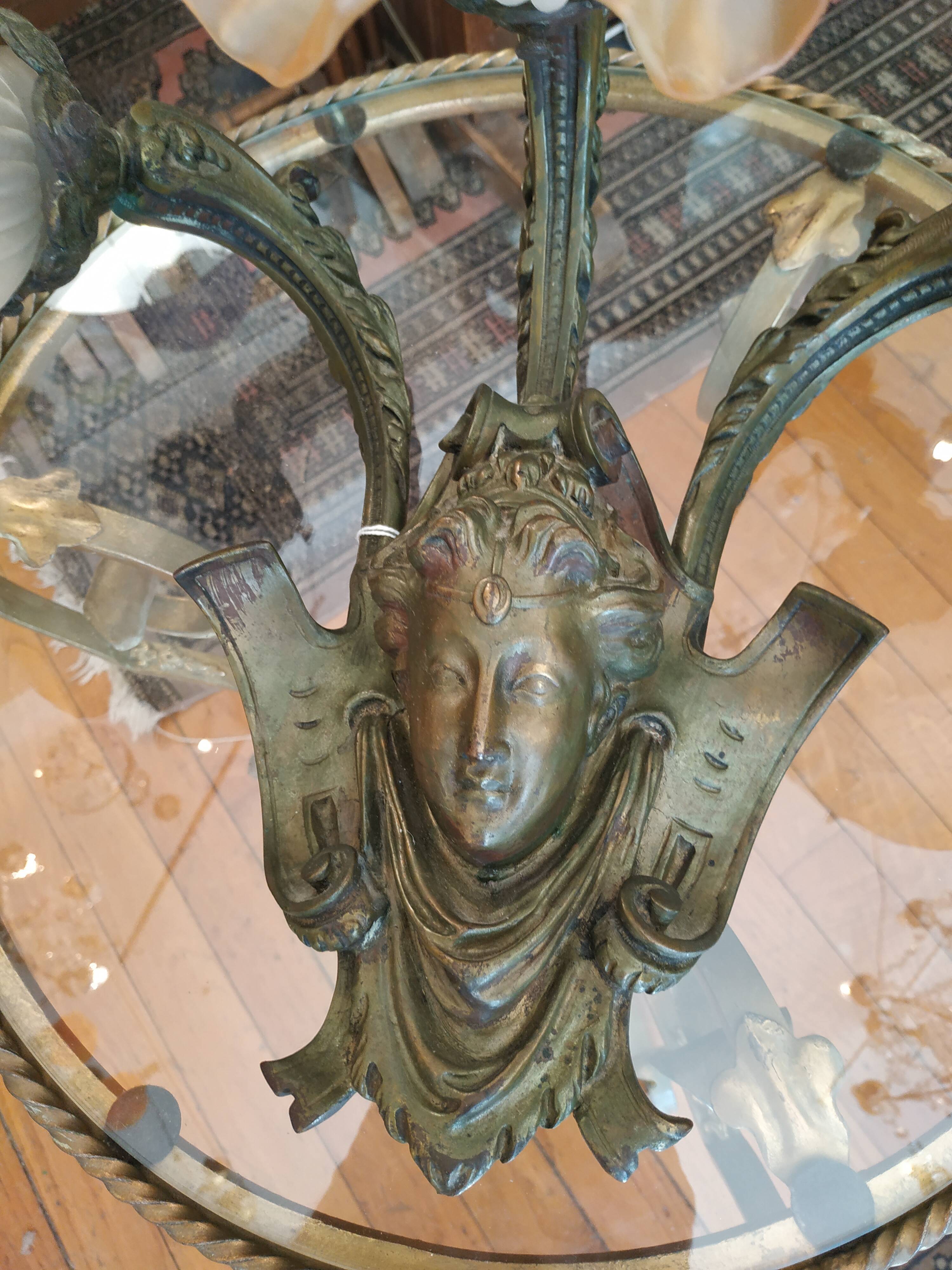 Bronze wall light patinated woman's head