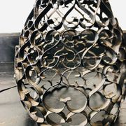 Black wrought iron lamp with a white glass globe.