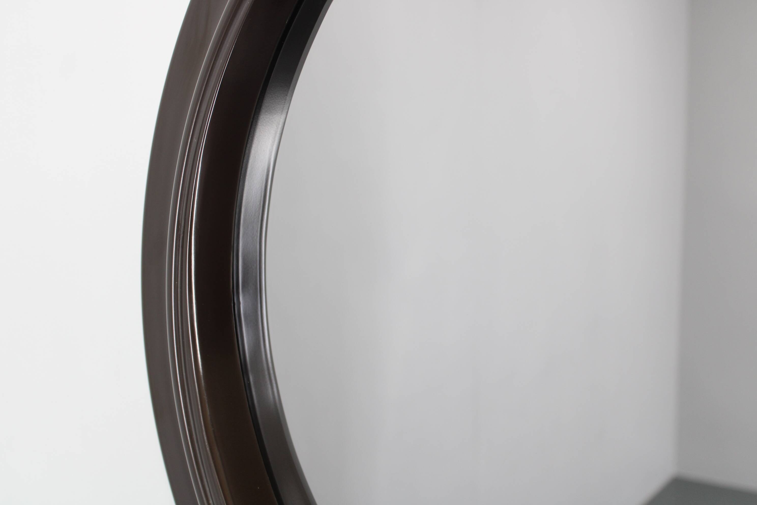 1970s Italian round mirror in dark brown plastic frame