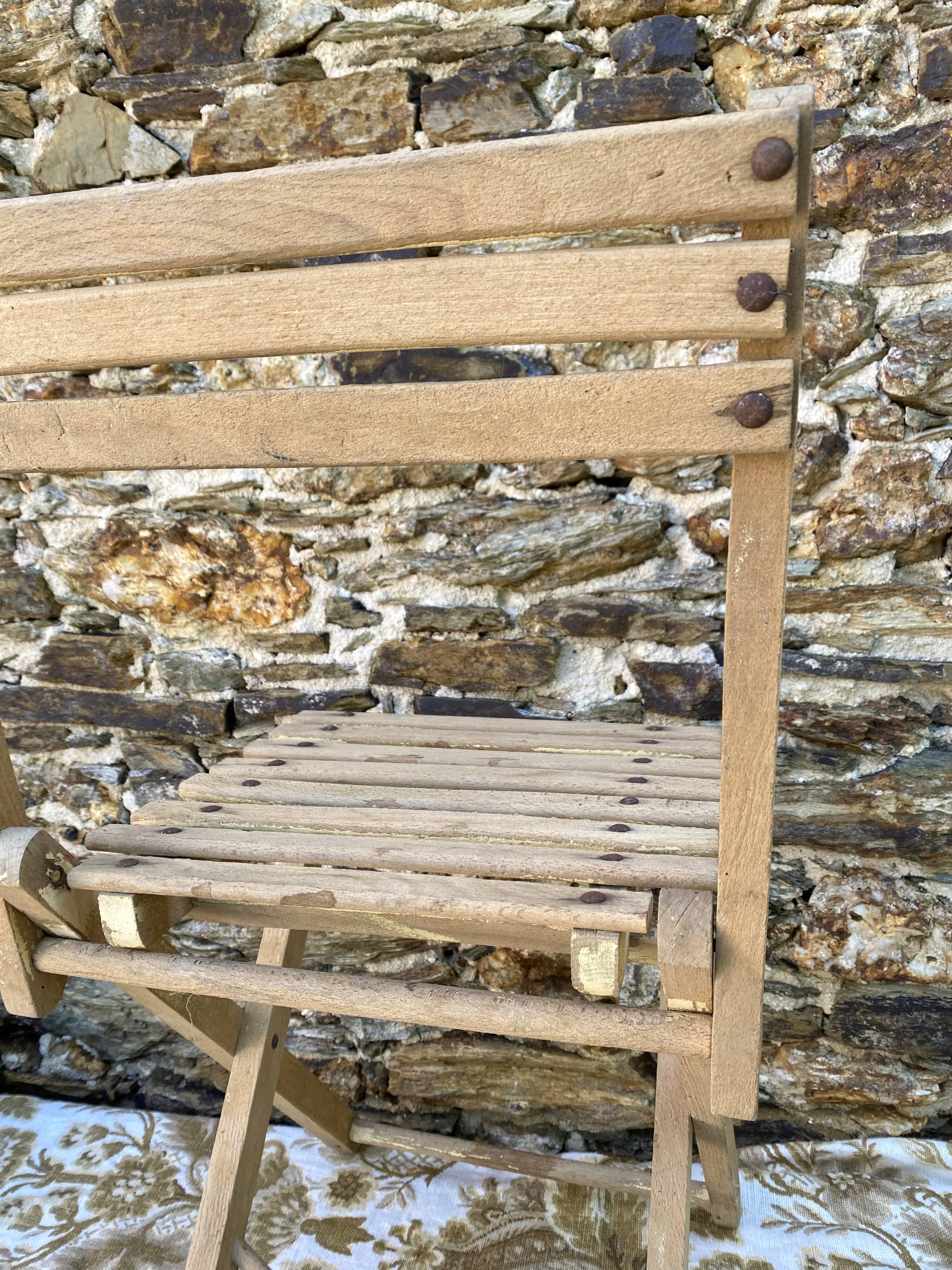 Antique folding chair with wooden slats