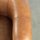 Sheepskin club armchair in a brown colour finished with decorative nails