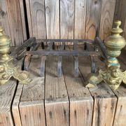 Pair of andirons and grates in cast iron and bronze with gilded grotesques, 17th century