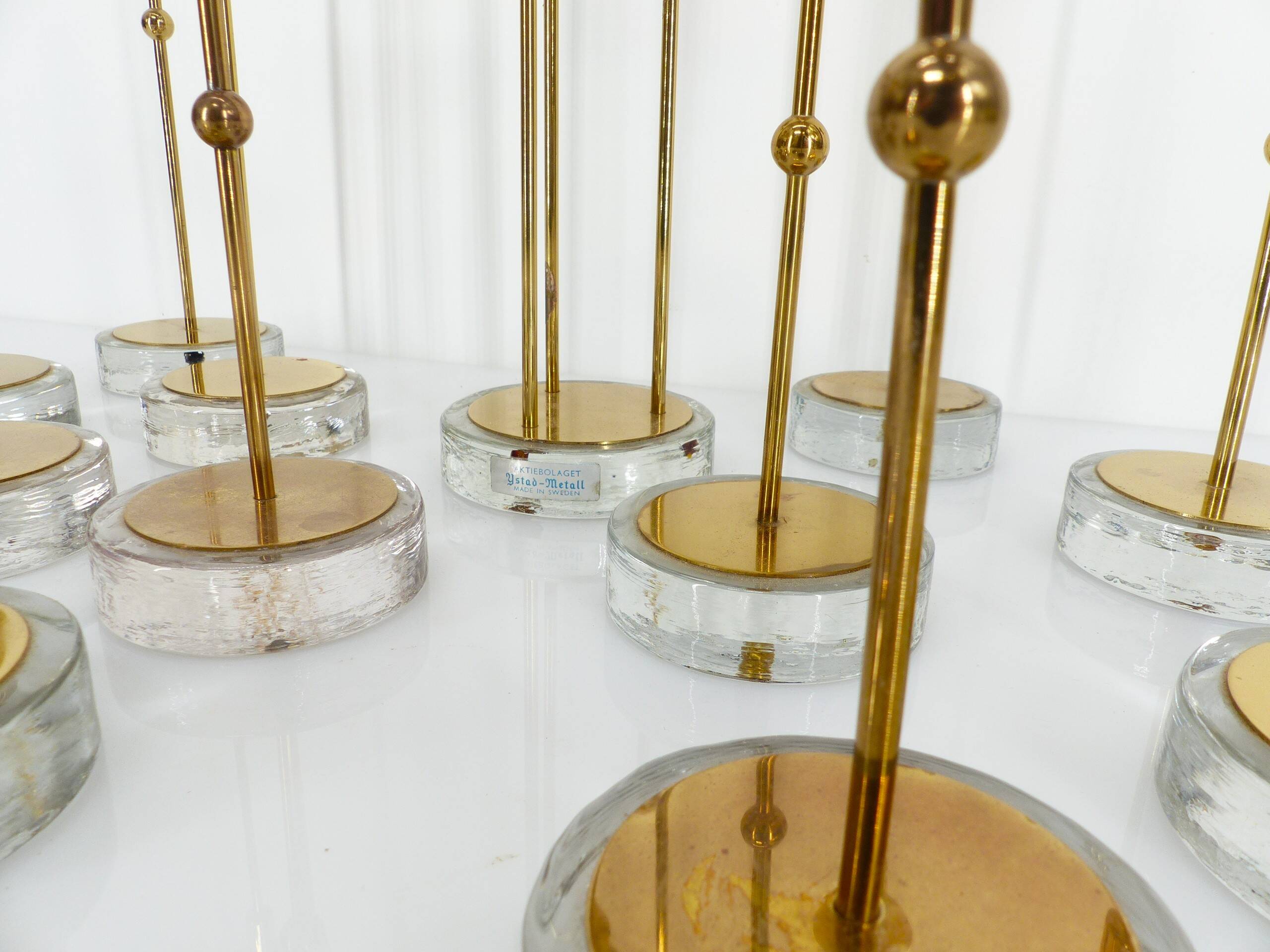 Set of 15 Scandinavian candle holders in brass and glass, Gunnar Ander, Ystad Met