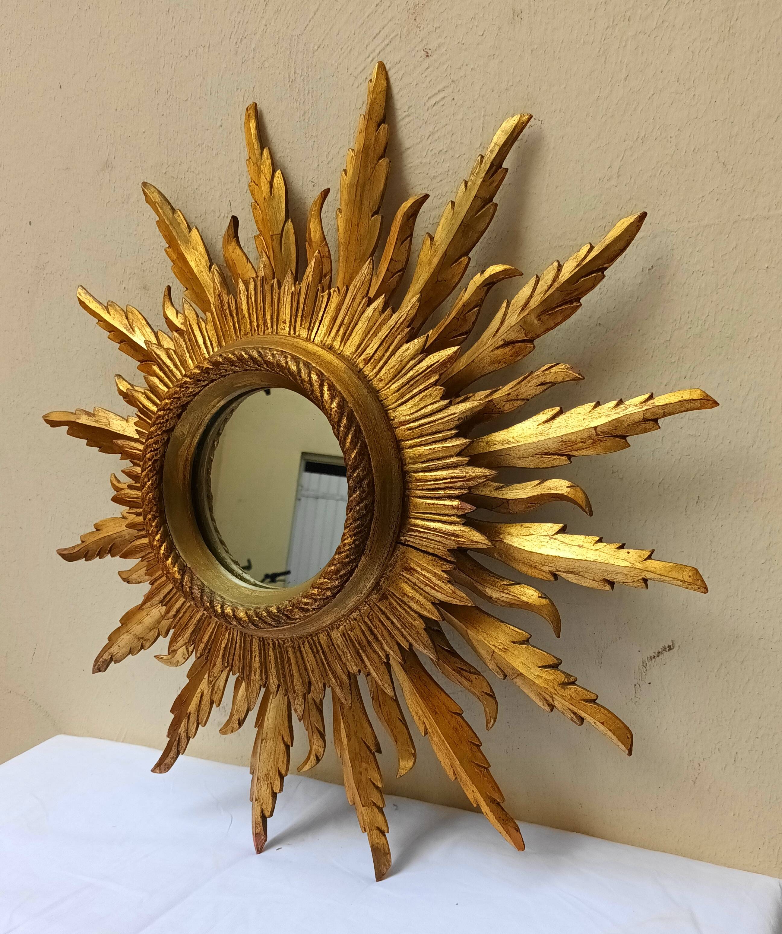 Sun mirror in carved gilded wood from the 1950s