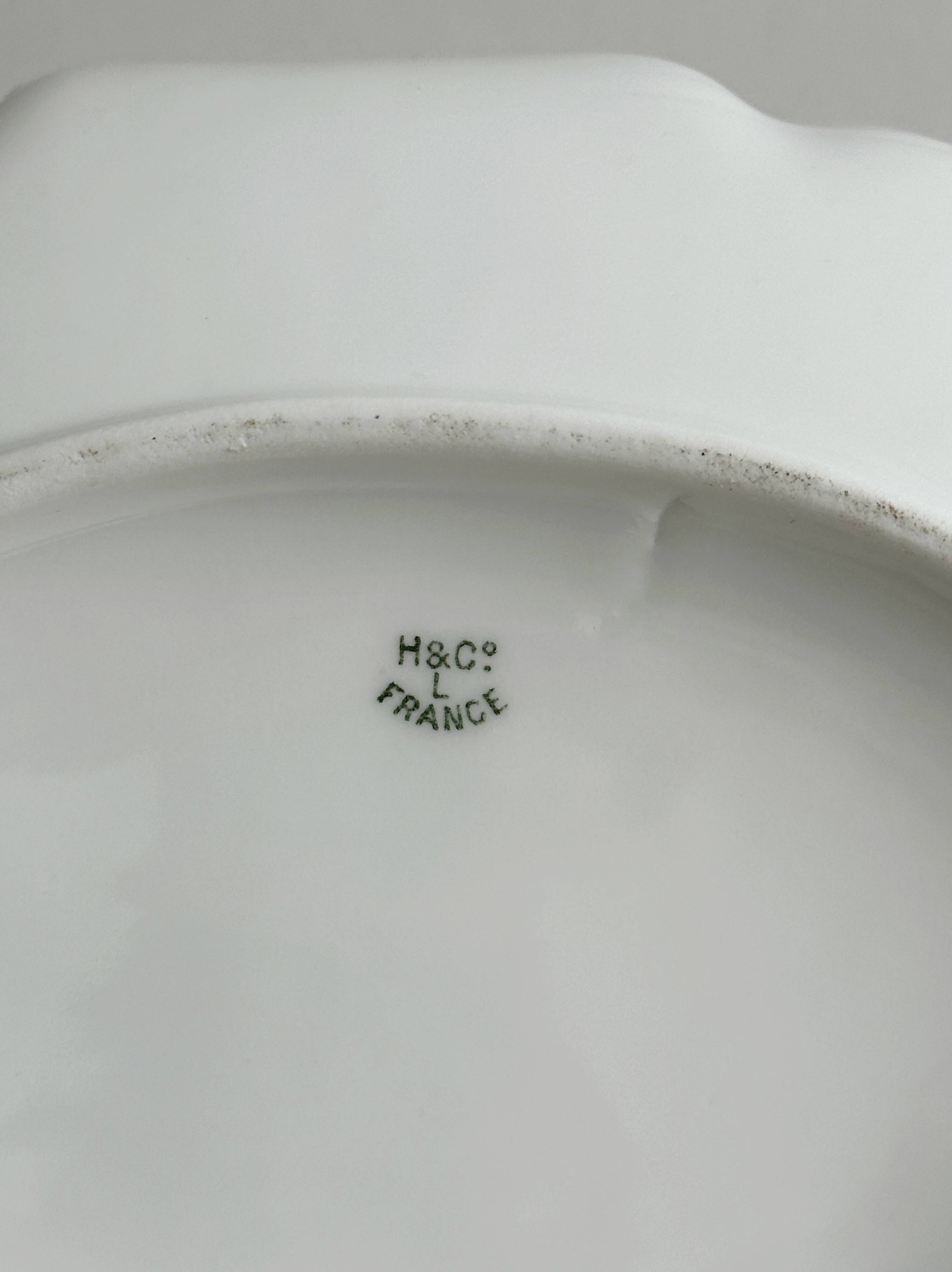 White fine porcelain soup tureen with relief decoration.