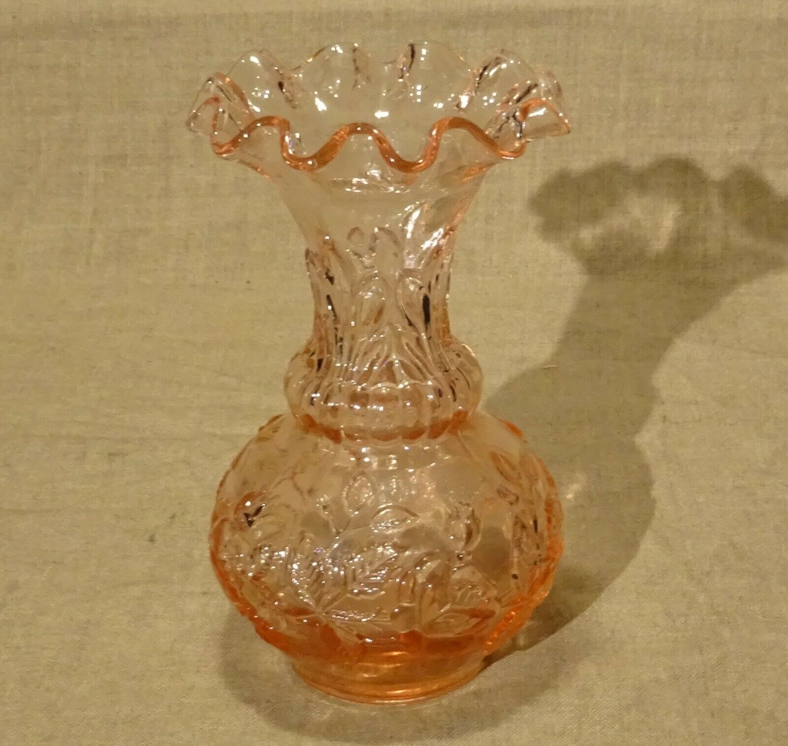 Pink molded pressed glass vase decorated with hazel foliage