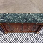 Flamed mahogany enfilade with sea green marble in Empire style.