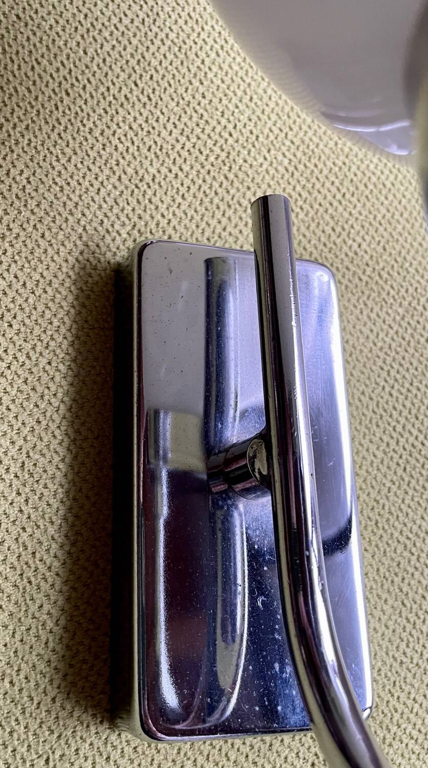 Pair of chrome metal wall lights with white glass globe.